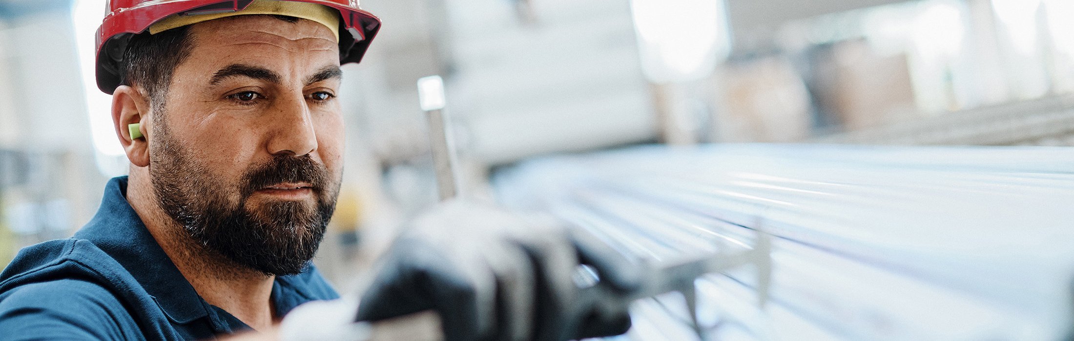 Quality assurance inspector examining steel tubes at Royal Van Leeuwen facility